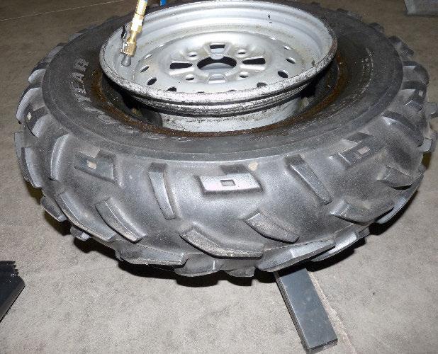 #01.109 Remove valve stem core from wheel. Set aside to replace later after bead is seated. Lubricate tire beads and rim flanges with approved tire lubricant. Before placing wheel on tire stand (Fig.