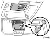 When the garage door opener transmitter is properly installed, you can operate the transmitter by pushing the center panel of the cover.