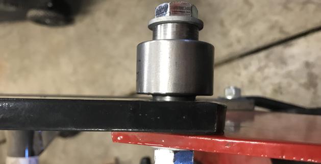 bushing on the outside (large end closest to parallel arm).