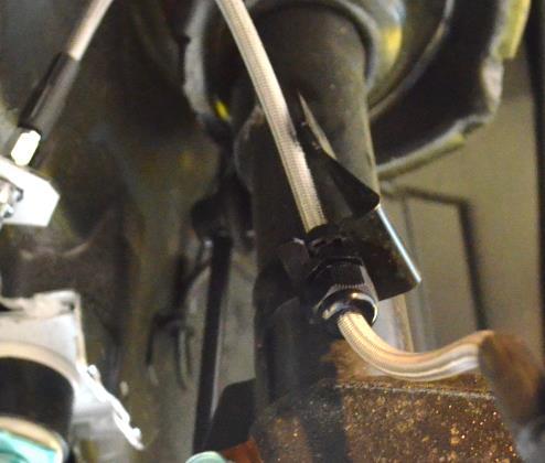 You will need to take pliers and bend the ends to make it fatter. This will allow enough tension to hold the brake line in place. Shown Figure 2k and installed in Figure 2l.