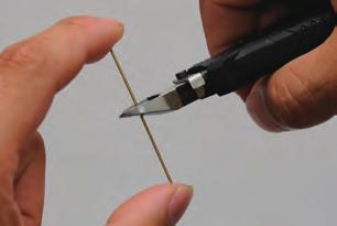 Tweezers Sandpaper Instant adhesive Cut the brass wire into four roughly equal lengths.