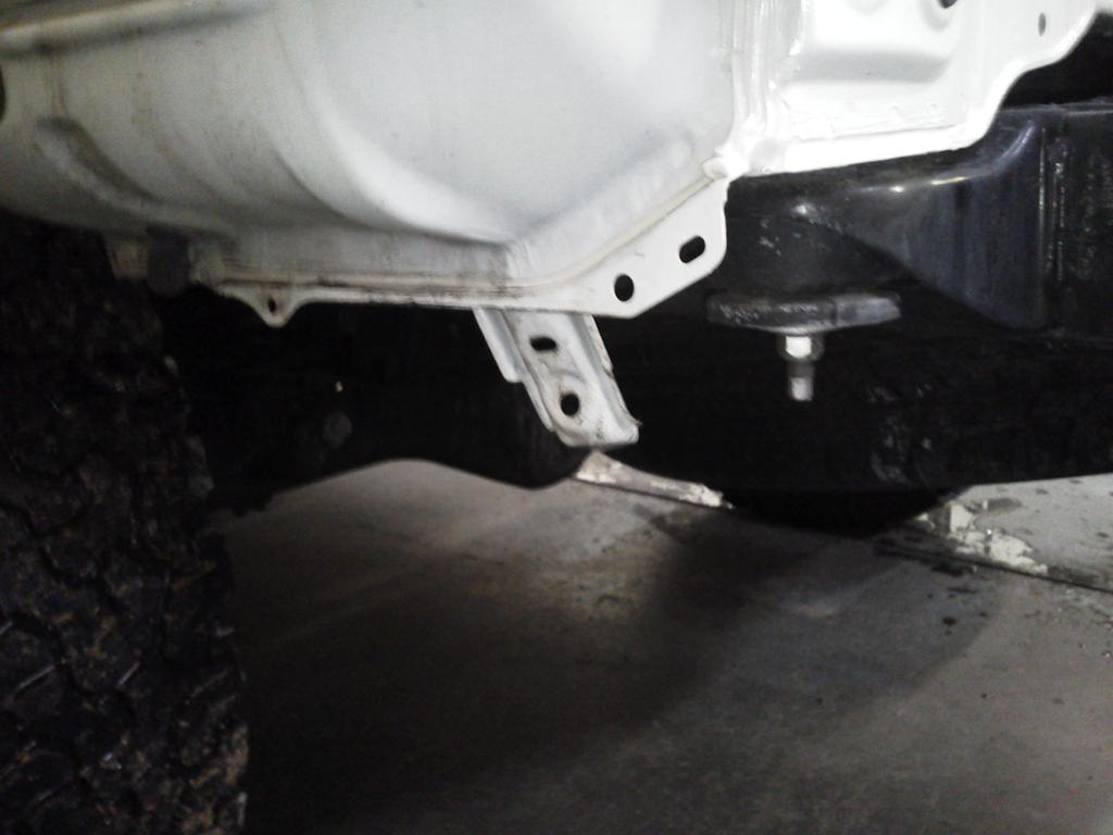 Step 4: Clearance. On each side of the fender there is a bracket that hangs down to attach the factory bumper cover to. Simply bend this bracket up toward the inside of the truck.