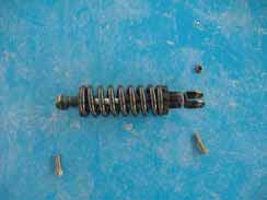 SECTION B-17: REAR SHOCK Preparations: Disassemble Left Side Body Panel see Section B-10 Unscrew the nut #1 by using a open wrench 14mm Unscrew the bolt #2 by using a open wrench 13mm Unscrew the