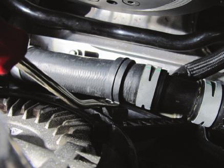 Detach the 1x plastic hose clamp securing the lower radiator hose to the radiator fan shroud. (See Fig. 1-w) Fig.