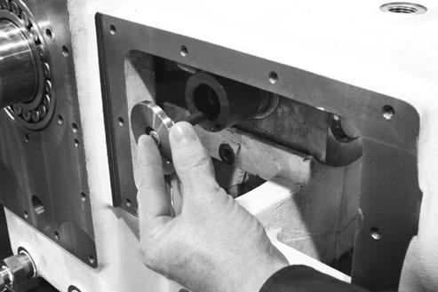 7. Install the retainer caps, through bolt stud and locknuts. Torque the locknuts to 25 ftlbs. The bottom clearance is to be checked with 0.0015 (0.0381 mm) feeler stock at the four (4) corners.