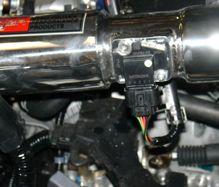 Close up of the air mass sensor connected to the machined adapter and the harness has been secured to the sensor.