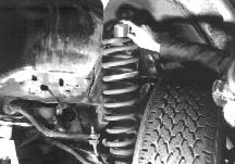 II. Install Lower Protector NOTE: If a bolt protrudes upward through spring retainer (Fig A), then tilt the coil spring