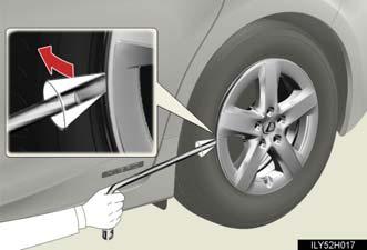 STEP 2 For vehicles with 15 inch wheels, remove the wheel ornament using the wrench.