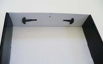2. Poke holes in the middle of both of the long side panels of the box, approximately 1/2 inch (1.3 cm) from the top edge of the box. Figure 6. Box with hole in the middle of the long side of the box.
