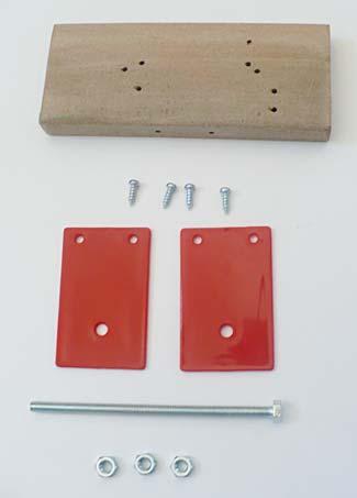 Figure 15. The following items are used to build the basic structure of the generator: pre-drilled wooden block, two red plastic panels, four short screws, three hex nuts, and one large bolt. 2.