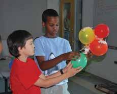 ) Show kids how the rubber bands can help them attach the balloons to the frame.