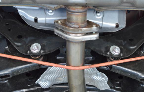 1. Removing the OEM Axle Back Section (continued) d) Using a bungee cord, floor jack, or friend, support the rear portion of the OEM midpipe section. See Figure 1c for clarity.