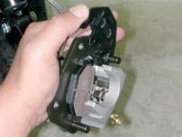 Front Brake Caliper Removal Place a container under the brake caliper, and loosen the brake hose bolt and finally