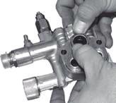 (See Figure 9) Remove the piston guides from the head by using a reverse plier (preferably rubber coated) inserted into the center of the piston guide.