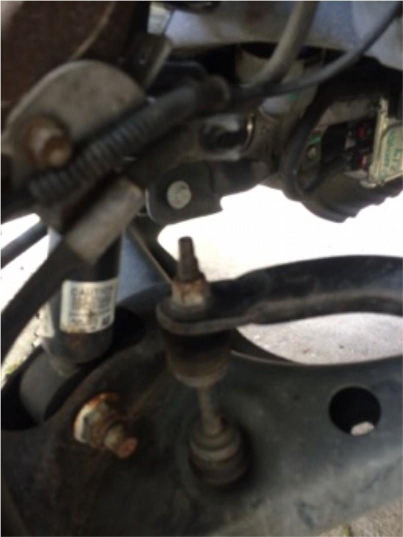 Step 6: Using an 18mm deep socket remove the upper sway bar link nut Step 7: Using either a 30mm deep socket 30mm wrench or adjustable wrench, hold the lower strut nut and using a 27mm socket and