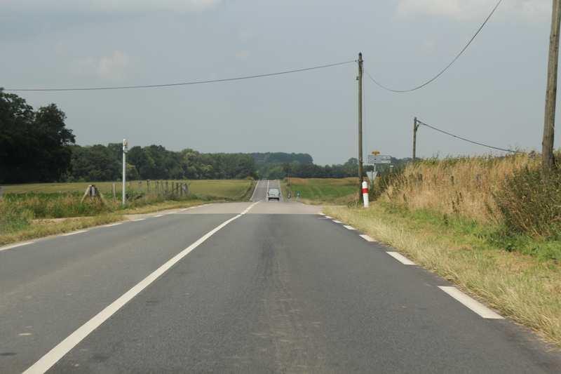 In order to improve its visibility triangle the driver is forced to encroach on the main road.