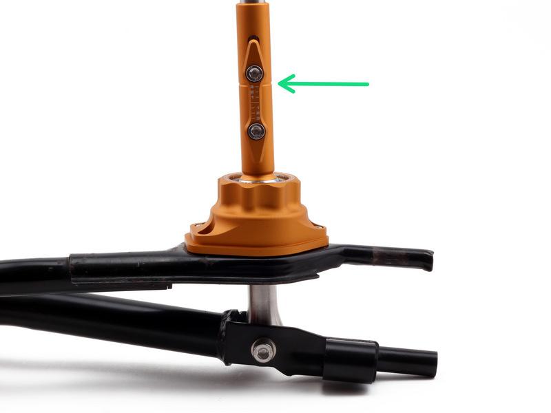 To adjust the shifter, loosen both hex bolts located on the side of the lower shifter sleeve. Slide the shifter upwards for a longer throw. Slide the shifter down for a shorter throw.
