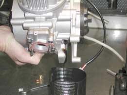 1). Fig.1 (14mm socket wrench) - TILT THE ENGINE TO DISCHARGE OIL (see Fig.2).