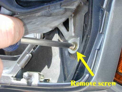 Remove the three screws. Set the mirror housing aside.
