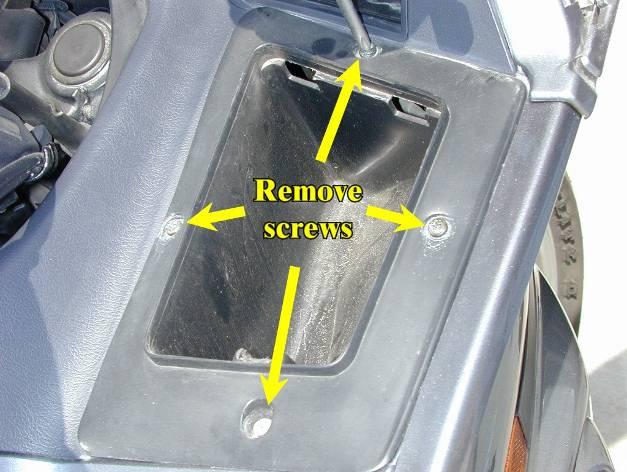 Remove the four screws on all sides of the accessory compartment.
