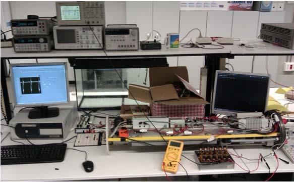 A) Block scheme of the battery charge test. Three battery packs, three digital multimeters, one voltage source and one laptop to monitor the variables.