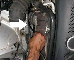 Step 11: Using a 10mm wrench, loosen the bolt that is on the passenger side chassis next to the turbo.