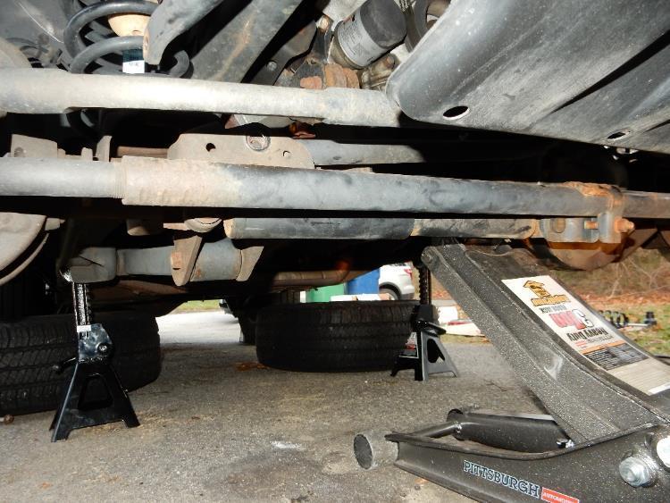 Place jack stands under the frame, lower the floor jack until the vehicles
