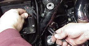 FL-E: Remove factory ECM located under the seat from the caddy by spreading the plastic caddy