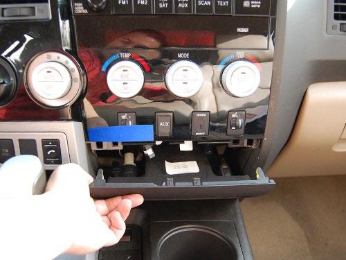 Apply protective tape to the bottom of the HVAC assembly. 2. Remove the lower console by hand or appropriate panel removal tool (Fig. 1-2).