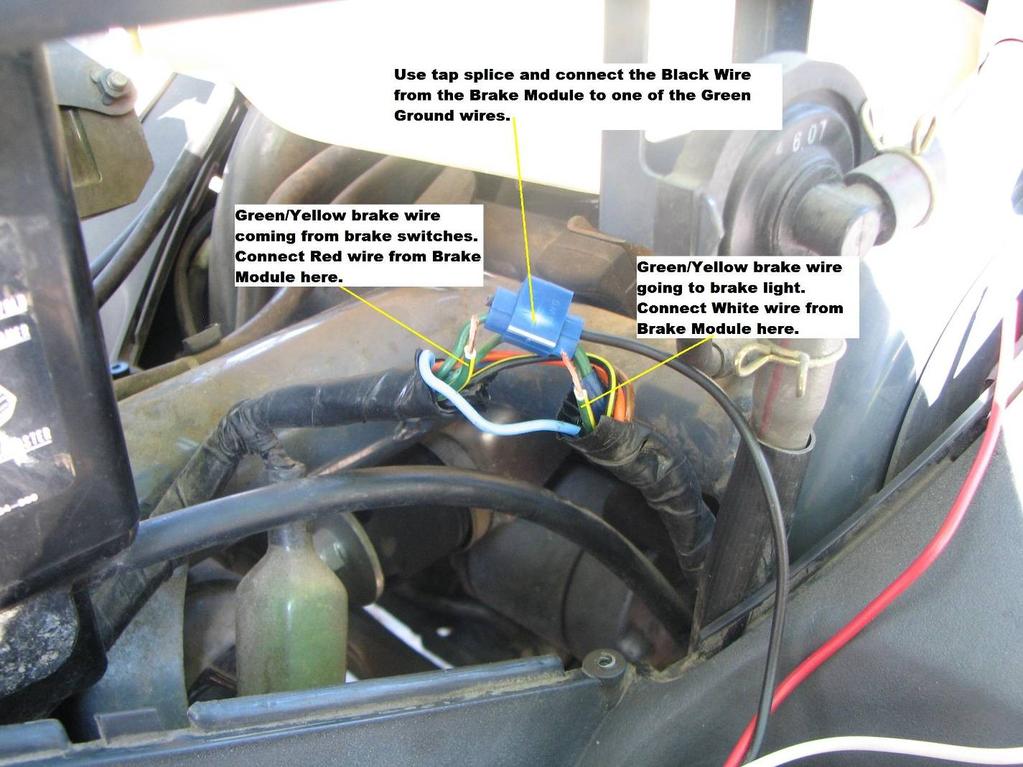 4. Attach the Black wire from the control module to one of the green ground wires using the included tap splice