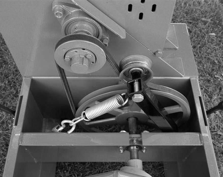 The WC1103 chipper uses (1) B-58 belt. Remove the idler spring to release the tension on the belt. Remove the bolts that attach the bearings and slide the shaft forward.