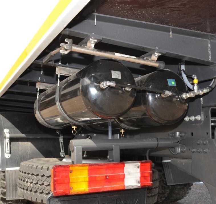 The air compressor is mounted on truck chassis, left-hand side.