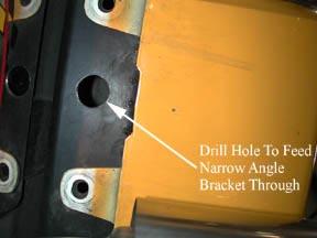 Find the black narrow stud plate that has two 5/16 bolts welded to it (part #8), insert it into the 1 ½ inch hole and drop the studs through the
