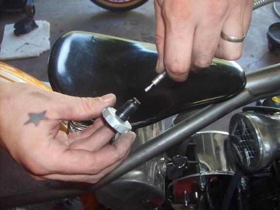 After putting the throttle cable through the retainer cap, pull as much free cable down as