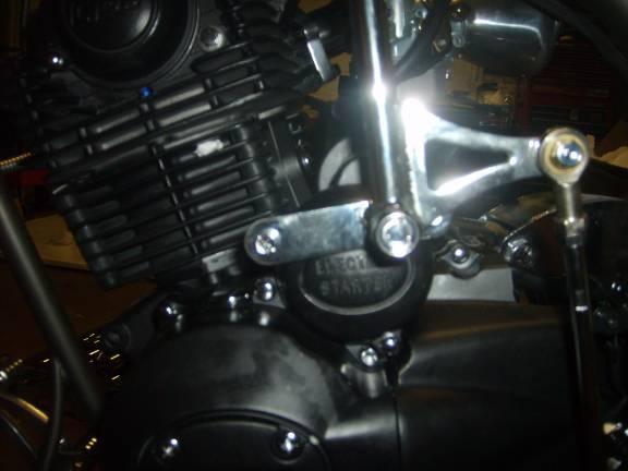 Step13. Installing the jockey shifter The top bracket mounts horizontally on the electric starter cover.