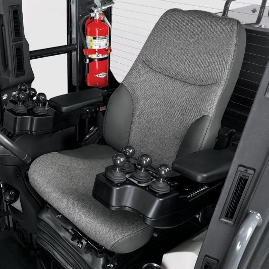 Eight armrest-mounted Ɵngertip-actuated controls, including steering lever, are arranged in the