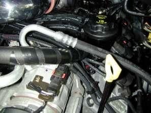 n. Wrap the helical plastic wrap around the breather hose where it passes under the A/C line. o. Plug in the IAT sensor.