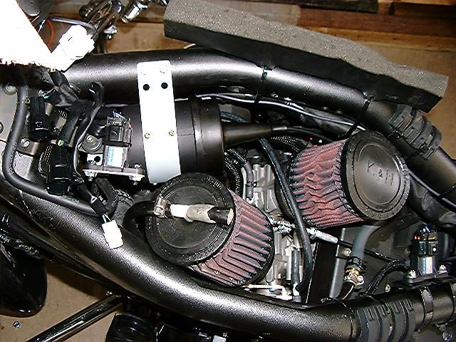 8a. For servo mounting behind the right saddlebag, route the servo throttle cable along the frame on the right side. Continue under the seat and along the left side.