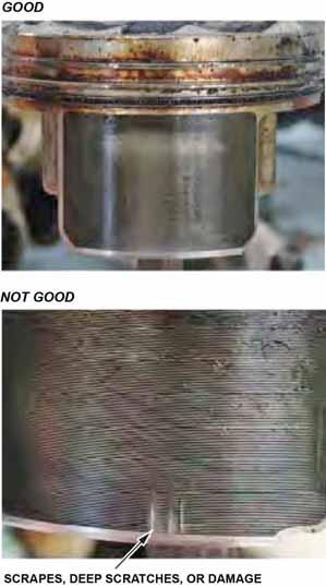 33. Remove the piston from the scratched cylinder bore. Inspect the piston skirt for any scratches or damage that corresponds with the scratched cylinder bore.