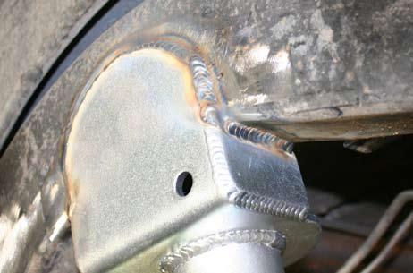 Reinstall the coil spring. 29. Tack the bracket into place. Make sure that the bracket lines up to the axle.