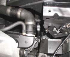 Listen for the click. Remove coolant and loosen coolant hoses.