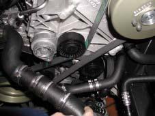 4 Remove engine cover (), back out bolt () and loosen clamps (). Remove air intake tract and intercooler hose. Back out bolts (4) and remove belt cover. ATTENTION!