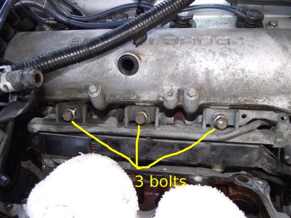 7. Remove the three bolts holding the fuel rail to the cylinder head. 8.
