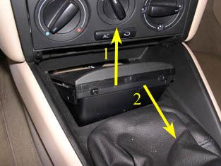 Once they're clear, slide the ashtray towards the rear of the car and out of the center console (2). 23.