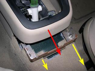 Once the bracket is out, you should be able to slide the lower center console backward (red arrow in picture below) and few inches and then up and over the shifter. 34.