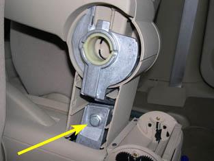 You can use a thin screwdriver protected by a thin rag to help ease the tabs out. 10. Remove the 13mm bolt in the picture below to remove the armrest.