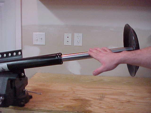 STEP 2 - USING AN IMPACT WRENCH, LOOSEN SPRING TENSION BOLT UNTIL ALL SPRING TENSION HAS