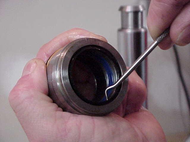 STEP 10 - USE A SUITABLE TOOL TO REMOVE BOTH SEALS FROM THE ROD GUIDE.