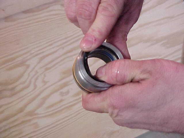 STEP 12-INSTALL THE NEW WEAR RING BY COMPRESSING IT UNTIL THE ENDS OVERLAP.