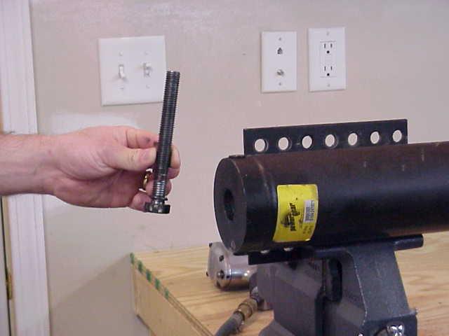 STEP 1 - (NOT SHOWN) - USING A PROPANE TORCH, HEAT THE CENTER BOLT FOR ONE (1) MINUTE.
